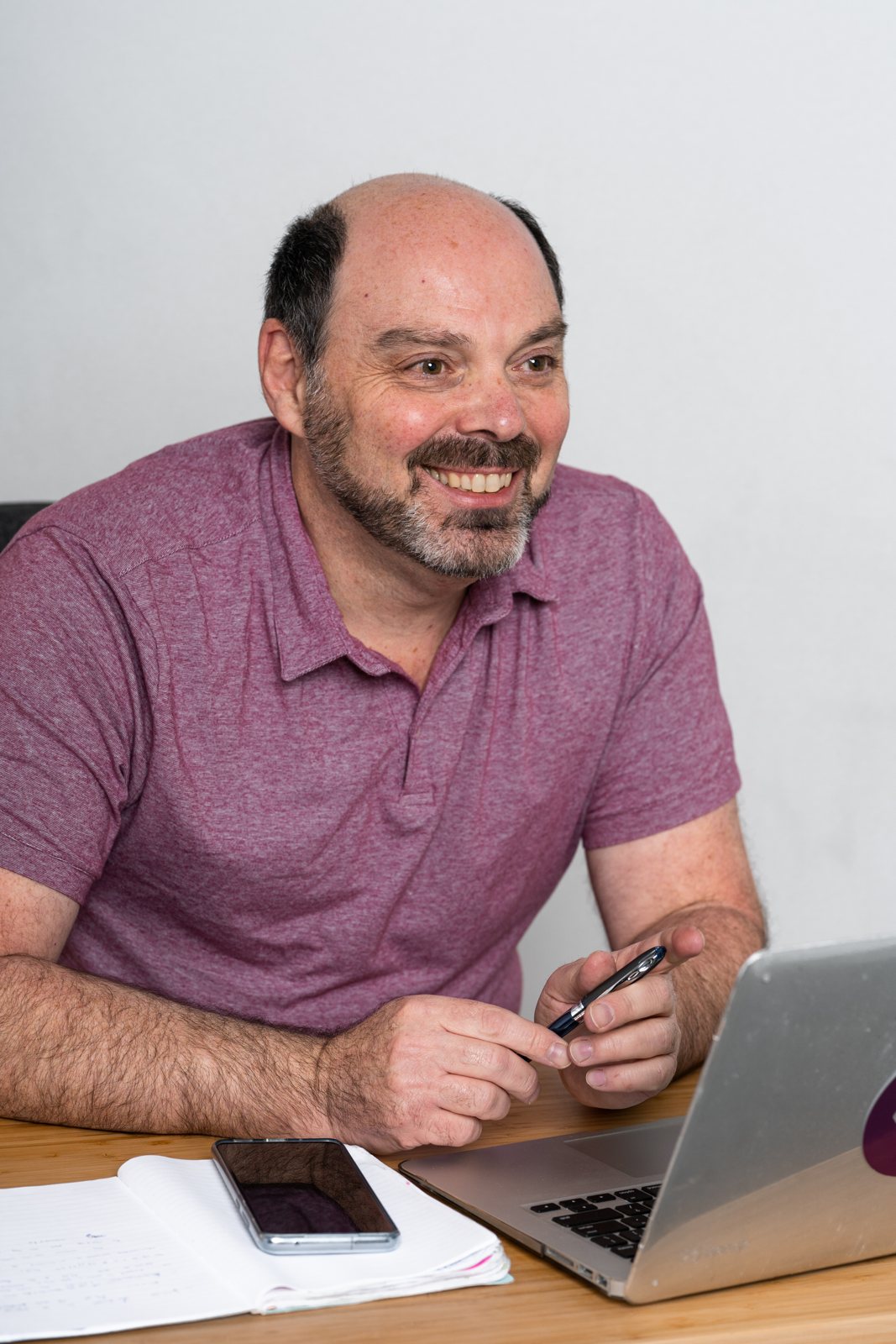 Morris Misel at his desk, smiling
