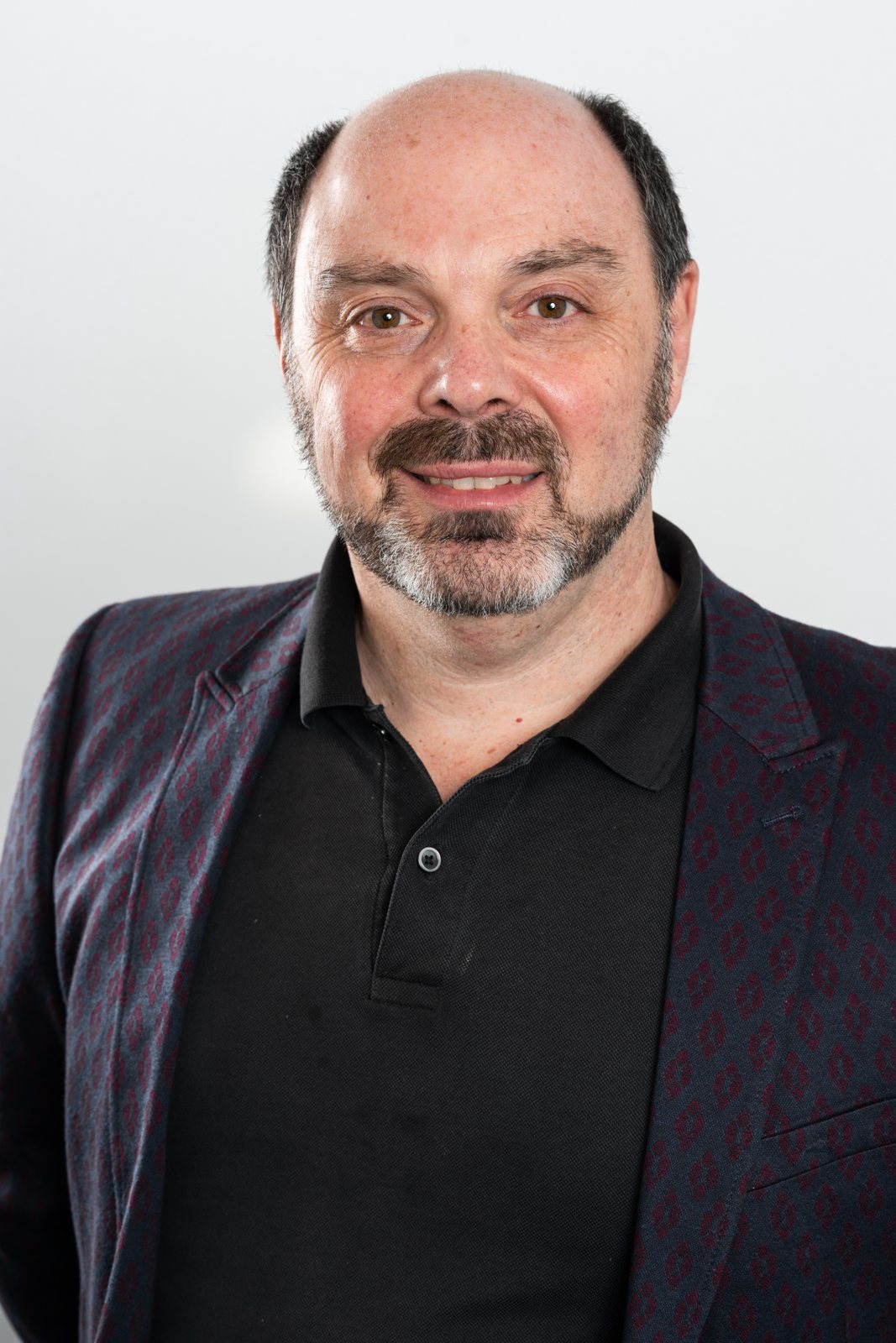 Morris Misel in a dark jacket, smiling at the camera